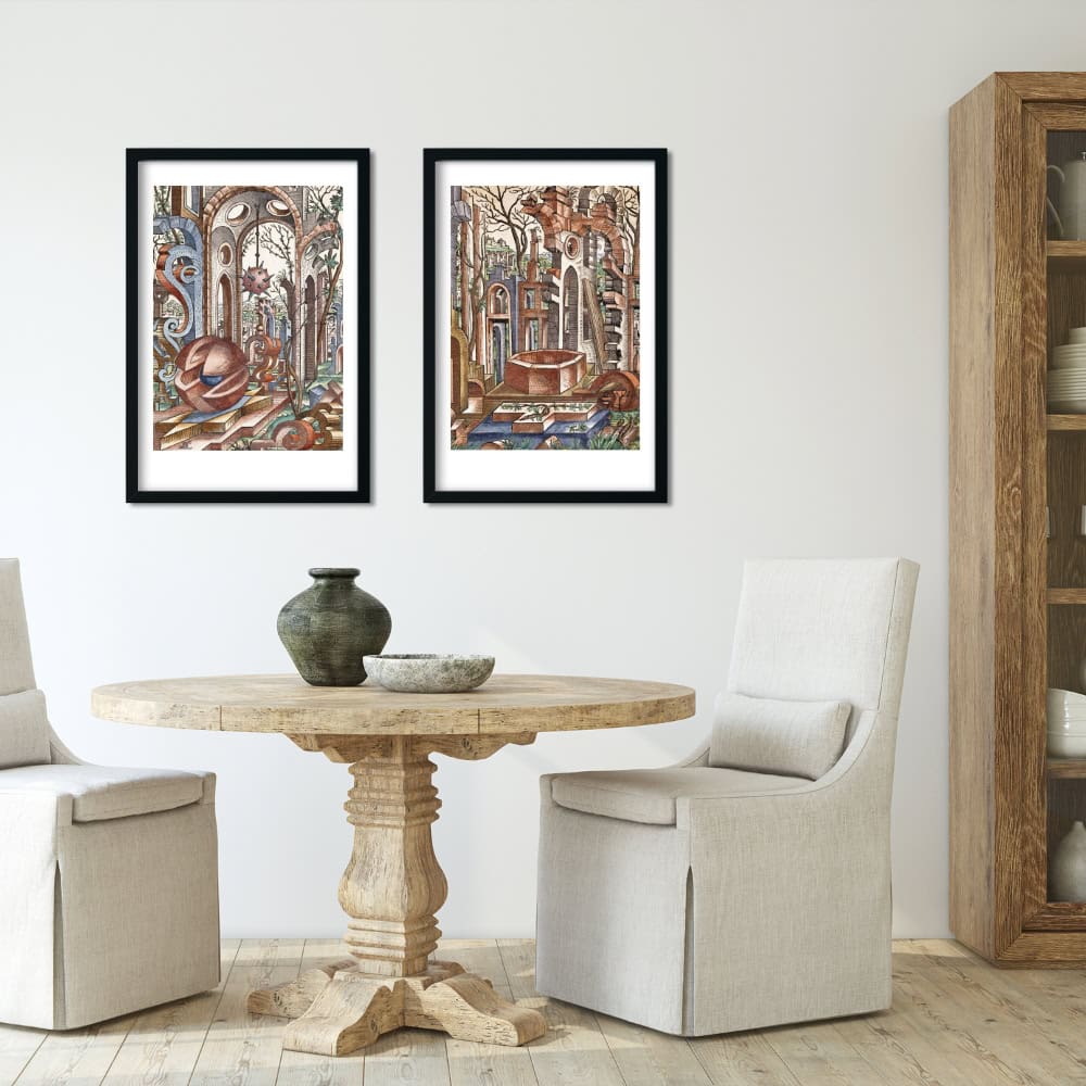 2 vintage architectural art prints of surreal ruins on wall above table and chairs